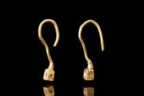 ROMAN GOLD PAIR OF EARRINGS

 Ca. 100-200 AD
 A nice pair of matched earrings crafted from gold, each earring features a round-section hoop with a ...