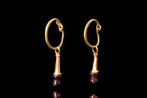 ROMAN GOLD PAIR OF EARRINGS

 Ca. 100-200 AD
 An opulent pair of matched earrings, crafted from gold, each earring features a round-section hoop wi...