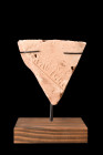 ROMAN TERRACOTTA BRICK WITH STAMP ON STAND 

 Ca. 100-300 AD
 A triangular-shaped fragment of terracotta brick, presenting an intriguing and except...