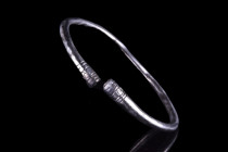ANCIENT ROMAN SILVER BRACELET

 Ca. 100-300 AD
 An elegant, penannular bracelet made of silver. The body is smooth, round-section, with incised des...