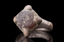 MEDIEVAL SILVER RING WITH GEM

 Viking Era, ca. 900-1100 AD
 A silver ring boasting a round hoop, skillfully fashioned with a rounded exterior and ...