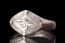 MEDIEVAL SILVER RING WITH SYMBOLS

 Viking Era, ca. 900-1100 AD
 A silver finger ring with a flat-section round hoop that gently widens to form a l...