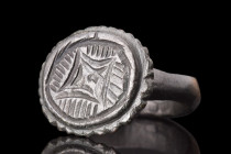 MEDIEVAL BRONZE RING WITH STAR OF BETHLEHEM

 Crusaders Era, ca. 1100-1400 AD
 A bronze finger ring with a slender hoop, finely etched shoulders, a...