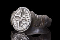 CRUSADERS ERA BRONZE RING WITH CROSS

 Ca. 1100-1400 AD
 A nice bronze ring with a plain, round hoop with decorative shoulders, slightly expanding ...