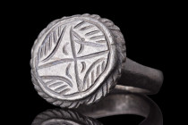 MEDIEVAL BRONZE RING WITH STAR OF BETHLEHEM

 Crusaders Era, ca. 1100-1400 AD
 A bronze finger ring with a circular band and a large bezel decorate...