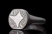 MEDIEVAL BRONZE RING WITH STAR OF BETHLEHEM

 Crusaders Era, ca. 1100-1400 AD
 A bronze finger ring with a circular band, that slightly expands to ...