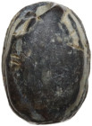 EGYPTIAN DARK SCARAB Egyptian world, c. 2nd-1st millennium BC. Egyptian scarab in dark stone with anatomical rendering of details in the convex part. ...