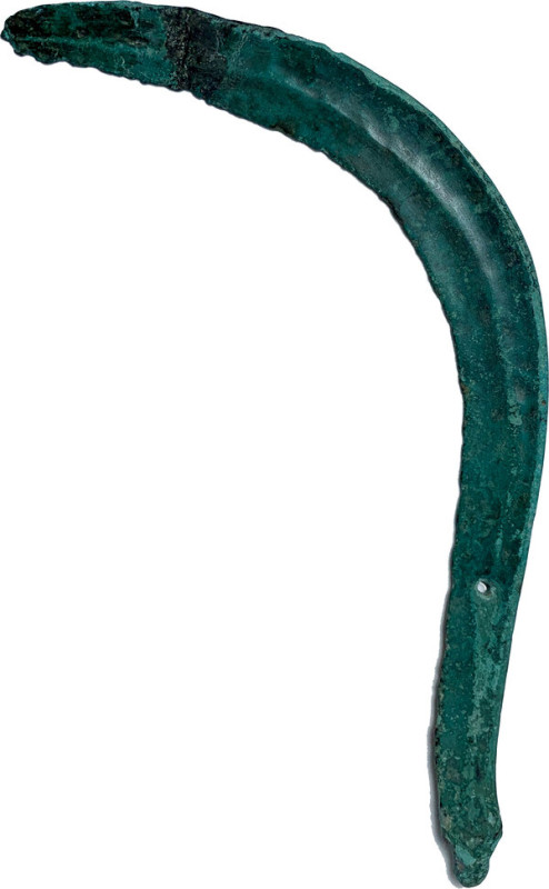 BRONZE AGE SICKLE. European Bronze Age, c. 800-600 BC. Bronze sickle, formed as ...
