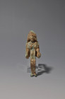 HISPANIA ANTIGUA. Cultura ibérica. Exvoto femenino con tocado (ss. VI-II a.C.). Bronce. Longitud 8 cm. Pérdidas matéricas en la pátina.