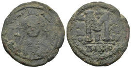 Justinian Æ Nummus. (35mm, 20.1 g) Constantinopolis, AD 527-565. D N IVSTINIANVS P P AVG, helmeted and cuirassed bust facing, holding globus cruciger ...