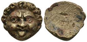 A bronze relief applique in the form of the head. 23mm, 13.3 gr.
