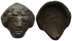 A bronze relief applique in the form of the head. 32mm, 24.42 gr.