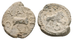PB Roman provincial. Asia Minor. Lead tessera (AD 2nd–4th centuries).
Obv: Stag standing, right. ΟΨΑ[…].
Rev: Lion advancing, right; before paw, globe...