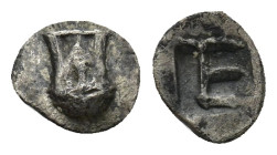 IONIA. Kolophon. Circa 500-450 BC. Tetartemorion (0.25 Gr. 6mm.). 
Facing head of Apollo with long locks. 
Rev. Monogram of TE (mark of value) within ...