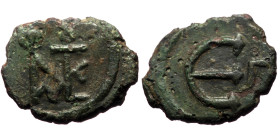 Justin II (565-578) Constantinople AE Pentanummium (Bronze, 15mm, 1.55g) 
Obv: Monogram of Justin and Sophia 
Rev: Large E, Γ to right. 
Ref: Sear 363...