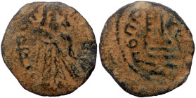 Islamic, Umayyad Caliphate. Abd al-Malik ibn Marwan, AE, Fals. (Bronze, 1.23 g. 19 mm). 685-705 AD / 65-86 AH.
Obv: Caliph standing facing, placing ha...