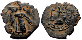 Islamic, Umayyad Caliphate. Abd al-Malik ibn Marwan, AE, Fals. (Bronze, 3.04 g. 20 mm). 685-705 AD / 65-86 AH.
Obv: Caliph standing facing, placing ha...