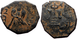 Islamic, Umayyad Caliphate. Abd al-Malik ibn Marwan, AE, Fals. (Bronze, 2.88 g. 21 mm). 685-705 AD / 65-86 AH.
Obv: Caliph standing facing, placing ha...