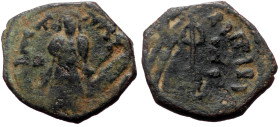 Islamic, Umayyad Caliphate. Abd al-Malik ibn Marwan, AE, Fals. (Bronze, 3.04 g. 20 mm). 685-705 AD / 65-86 AH.
Obv: Caliph standing facing, placing ha...