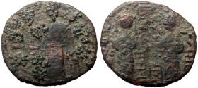 Zangids of Syria, Nur al-Din Mahmud (1146-1174) AE fals [Halab] 
Obv: two Byzantine-style figures standing facing, holding labarum between them, ruler...