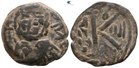 Time of Muhammad and the Rashidun AD 622-651. AH 1-30. Imitating an RY 4 half follis of Justinian I. Uncertain mint. Fals Æ