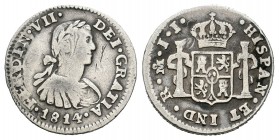 Fernando VII (1808-1833). 1/2 real. 1814. México. JJ. (Cal-1345). Ag. 1,62 g. Busto imaginario. Parte de la leyenda de reverso calcada en anverso. MBC...