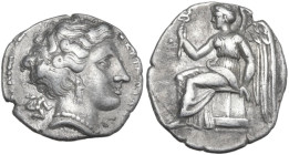 Greek Italy. Bruttium, Terina. AR Drachm, c. 300 BC. Obv. ΤΕΡΙΝΑΙΩΝ. Head of nymph right; triskeles behind. Rev. Nike seated left on plinth, holding k...