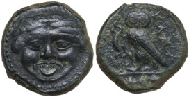 Sicily. Kamarina. AE Tetras or Trionkion, c. 420-405 BC. Obv. Gorgoneion. Rev. KAMA. Owl standing left, head facing, grasping lizard; three pellets in...