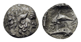 Islands of Thrace, Thasos, c. 412-404 BC. AR Tritartemorion (8mm, 0.32g). Head of satyr r. R/ Two dolphins swimming in opposite directions within shal...