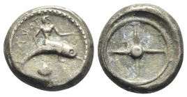 Southern Apulia, Tarentum, c. 480-470 BC. Replica of AR Nomos (18.5mm, 6.89g). Taras riding dolphin r.; cockle shell below. R/ Wheel of four spokes. C...