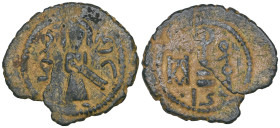 Arab-Byzantine, temp. ‘Abd al-Malik b. Marwan, fals, Harran, standing figure of caliph, hand on sheathed sword, Muhammad Harran, rev., modified cross ...