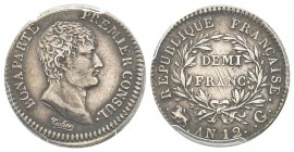 Premier Consul 1799-1804
Demi Franc, Genève, AN 12 G, AG 2.5 g. Ref : G.394 Conservation : PCGS AU50. Presque Superbe et Rare
