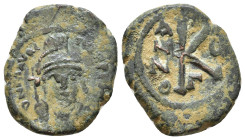 Maurice Tiberius. 582-602 AD. Half Follis. Constantinople. Helmeted, draped and cuirassed bust facing, holding globus cruciger and shield decorated wi...