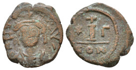 Maurice Tiberius. 582-602 AD. AE 10 Nummi. Constantinople. Helmeted, draped, and cuirassed bust facing. / Large I between star and Γ; above, cross; in...