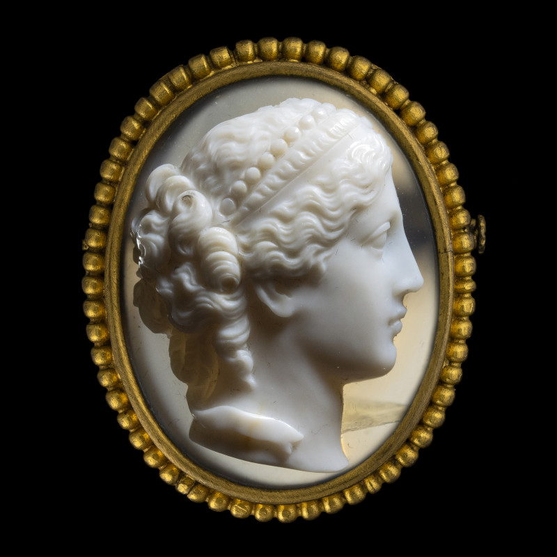 BROCHE
En métal doré sertie d'un camée sur agate figurant une tête de femme à l...