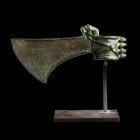 *HACHE CÉRÉMONIELLE
En bronze à patine verte, la tige nervurée à quatre pointes et surmontée d'un lion. La lame à courbe évasée vers le bas présente ...