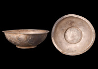 HELLENISTIC SILVER LIBATION BOWL

 Ca. 4th-3rd century BC
 A silver libation bowl, skillfully crafted from silver. The bowl's distinctive character...