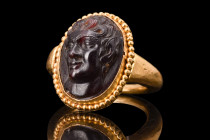 ROMAN SATYR GARNET CAMEO IN A SOLID GOLD RING

 Ca. 4th-6th Cen. AD
 An amethyst cameo portraying a finely rendered portrait of a satyr, a mytholog...