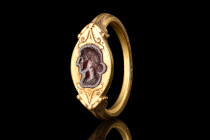 RARE ROMAN GOLD RING WITH GARNET INTAGLIO WITH FAUSTINA JUNIOR 

 Ca. late 2nd century AD
 A gold ring with a D-shaped design, characterized by a r...