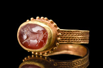 ROMAN GOLD RING WITH HIGH QUALITY WILD BOAR GARNET INTAGLIO 

 Ca. 100-200 AD
 A high quality garnet intaglio presents a captivating portrayal of a...