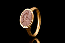ROMAN GOLD RING WITH JASPER GRYLLOS INTAGLIO

 Ca. 100-300 AD
 A fine gold finger ring of a round-section hoop expanding to form an oval bezel set ...