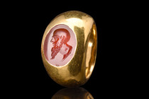 ROMAN GOLD RING WITH CARNELIAN INTAGLIO OF SOCRATES

 Ca. 100-300 AD
 A high carat gold ring set with carnelian intaglio with a captivating depicti...