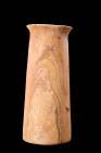 EGYPTIAN ALABASTER VESSEL

 The Third Dynasty, ca. 2650-2575 BC
 A tall cylindrical vessel with a flaring rim, featuring a flat circular base and a...