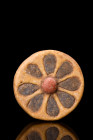 EGYPTIAN ROSETTE INLAY

 Ca.1184-1153 BC
 A round-shaped glazed faience composition set with blue lapis lazuli petals on a yellowy brown background...