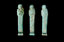 COLLECTION OF THREE EGYPTIAN FAIENCE USHABTIS

 Late Period, 30th Dynasty, Ca. 332 BC
 A group of three light blue faience ushabti figures, each ex...