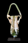 ROMAN GLASS DOUBLE BALSAMARIUM

 Ca. 1-200 AD
 A double balsamarium crafted from pale green glass, displaying meticulous modeling and attention to ...
