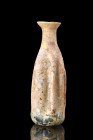 ROMAN GLASS RIBBED BOTTLE

 Ca. 200-300 AD
 A beautiful glass bottle with a long body displaying vertical grooves, a short, flared neck and a wide ...