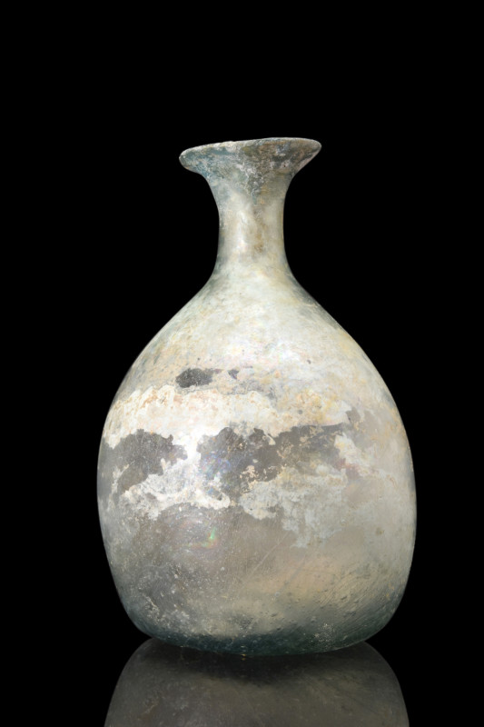 ROMAN GLASS GLOBULAR FLASK

 Ca. 100-300 AD
 A glass flask features a distinc...