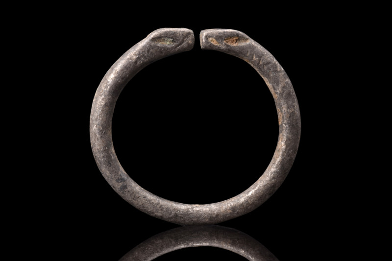 CELTIC SILVER RING WITH SNAKE HEADS 

 Ca. 100 BC
 A silver ring featuring a ...