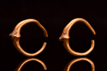 EASTERN GREEK GOLD PAIR OF EARRINGS

 Ca. 800 BC
 A matched pair of gold earrings crafted with meticulous precision. Each earring features a round ...